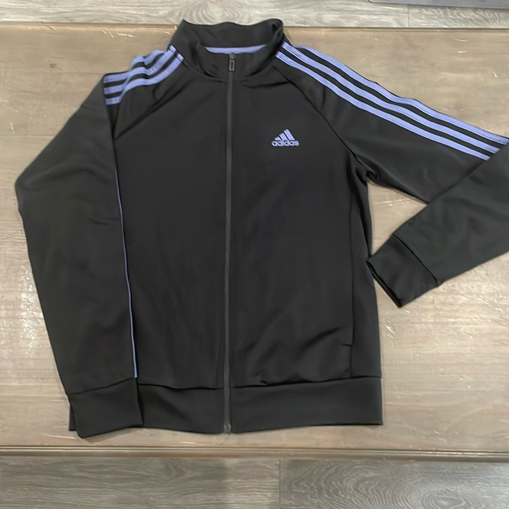 Woman’s Adidas zip up jacket in black and lilac size Medium.